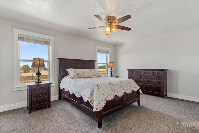 carpeted bedroom with a ceiling fan and baseboards