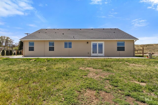 back of house with a yard and a patio area
