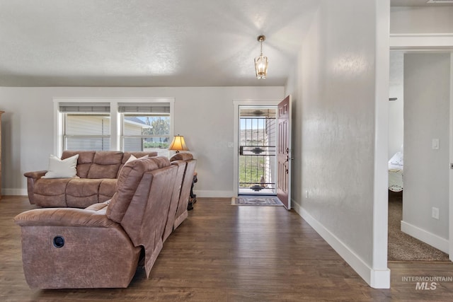 living room featuring dark wood finished floors and baseboards