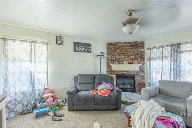 carpeted living room with a textured ceiling and a fireplace