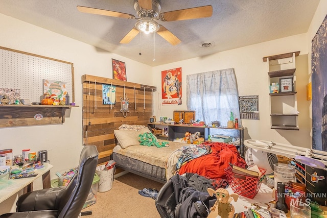 carpeted bedroom with ceiling fan and a textured ceiling