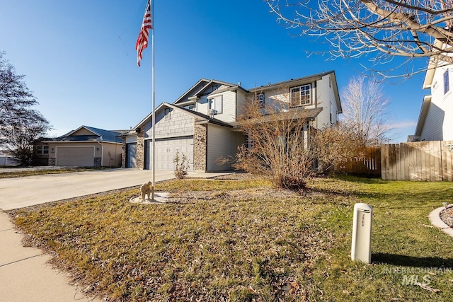 view of front of house featuring a front yard and a garage