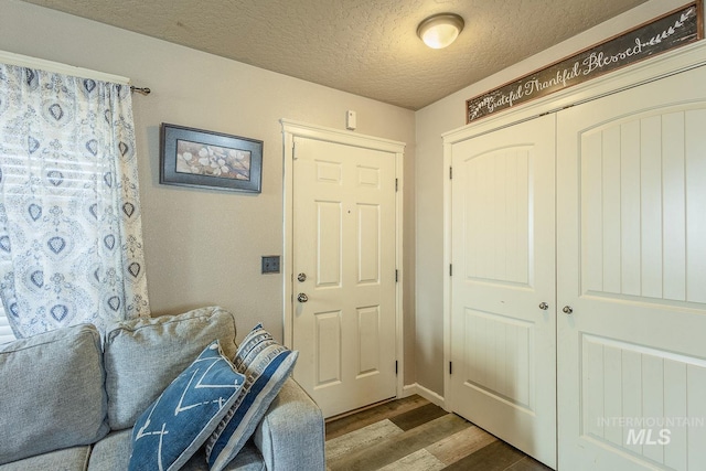 foyer entrance with a textured ceiling and hardwood / wood-style floors