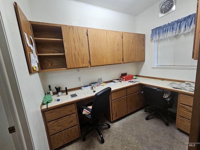 office space with built in study area and visible vents