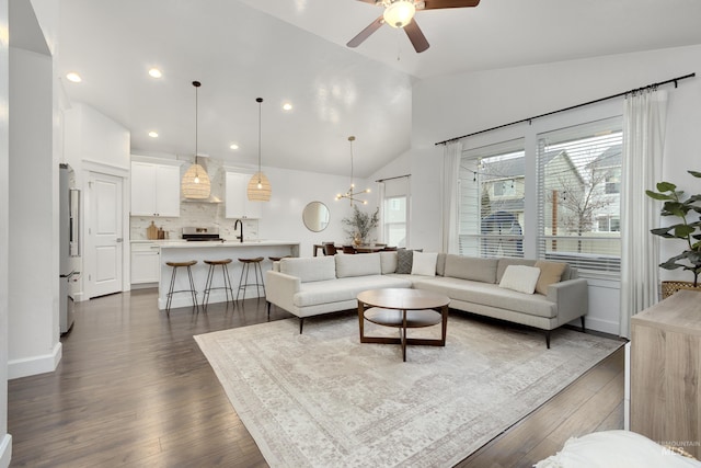 2935 NW 8th Ave, Meridian, ID 83646 - living room with vaulted ceiling, a ceiling fan, dark wood-style flooring, a chandelier, and recessed lighting