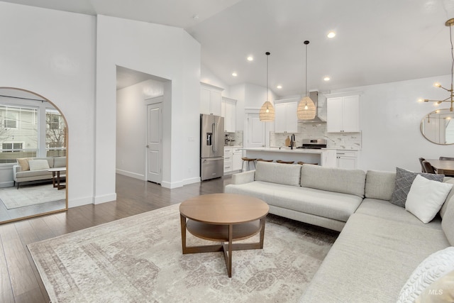 2935 NW 8th Ave, Meridian, ID 83646 - living room featuring a chandelier, dark wood-style flooring, vaulted ceiling, recessed lighting, and baseboards