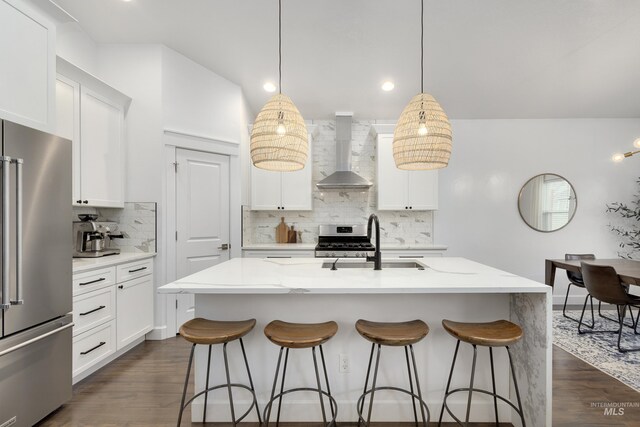 2935 NW 8th Ave, Meridian, ID 83646 - kitchen with appliances with stainless steel finishes, wall chimney exhaust hood, a sink, backsplash, and a kitchen bar