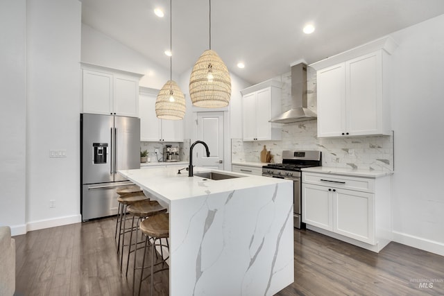 2935 NW 8th Ave, Meridian, ID 83646 - kitchen featuring appliances with stainless steel finishes, wall chimney exhaust hood, a sink, backsplash, and a breakfast bar