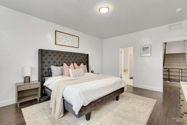 2935 NW 8th Ave, Meridian, ID 83646 - bedroom with dark wood-style floors, baseboards, and ensuite bathroom