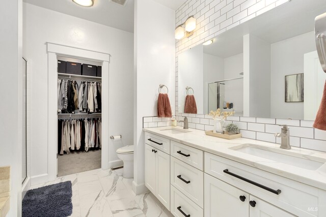 2935 NW 8th Ave, Meridian, ID 83646 - bathroom featuring marble look tiles, a stall shower, double vanity, toilet, and tasteful backsplash