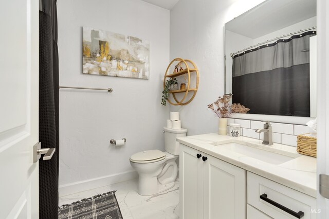 2935 NW 8th Ave, Meridian, ID 83646 - full bath featuring marble look tiles, toilet, tasteful backsplash, vanity, and baseboards