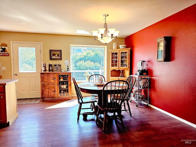 dining room featuring dark hardwood / wood-style floors and a notable chandelier