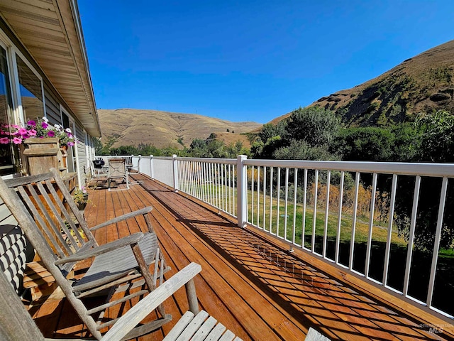 wooden deck featuring a mountain view