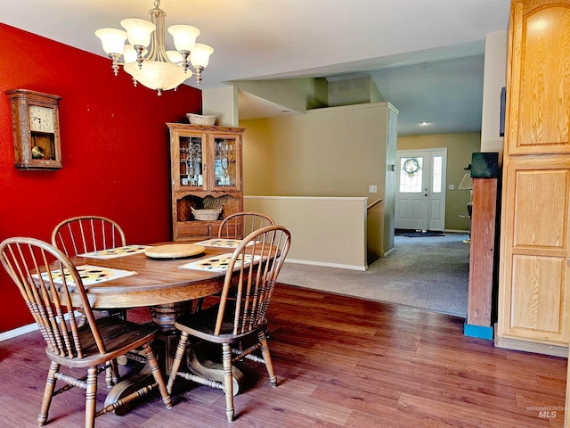 carpeted dining room with a notable chandelier