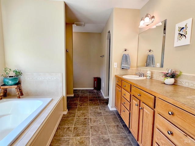 bathroom featuring tile flooring, oversized vanity, and tiled bath