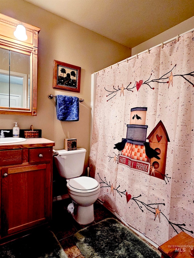 bathroom featuring tile floors, toilet, and vanity