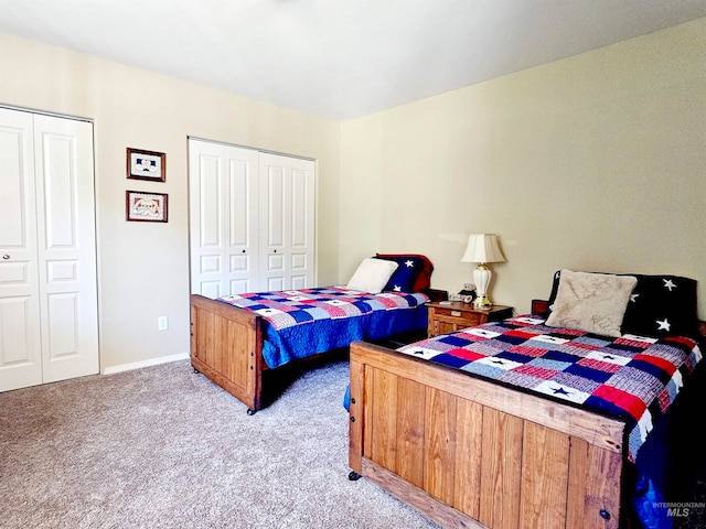 carpeted bedroom with two closets