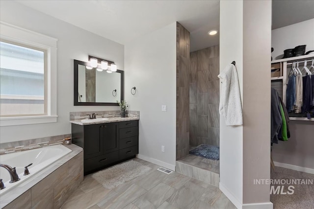 bathroom with plus walk in shower and vanity