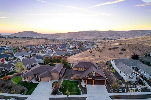 aerial view at dusk featuring a mountain view