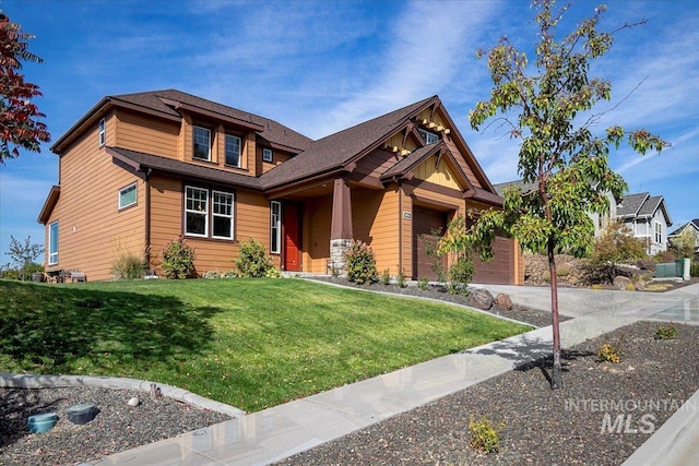 view of front of house featuring a front yard and a garage