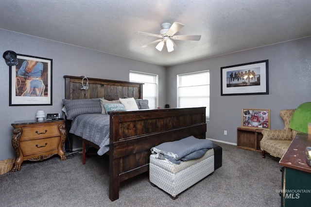 bedroom with ceiling fan, carpet flooring, baseboards, and a textured ceiling