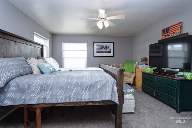 bedroom featuring a textured ceiling, ceiling fan, and carpet flooring