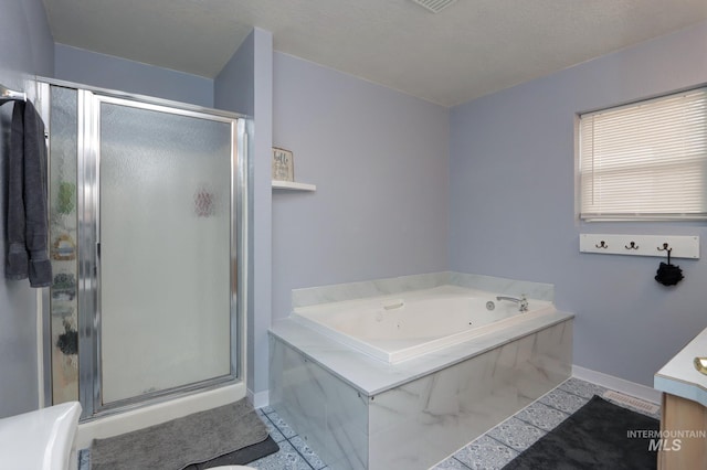 bathroom featuring baseboards, vanity, a jetted tub, and a shower stall