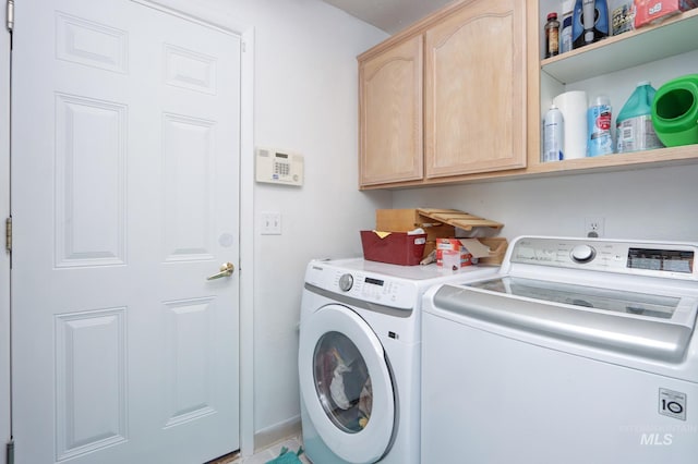 laundry area featuring cabinet space and separate washer and dryer