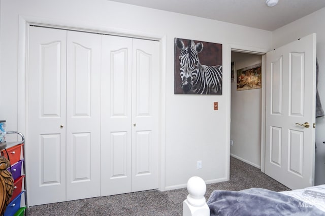 bedroom with a closet, carpet floors, and baseboards