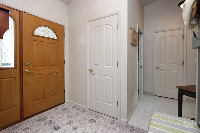 foyer featuring baseboards