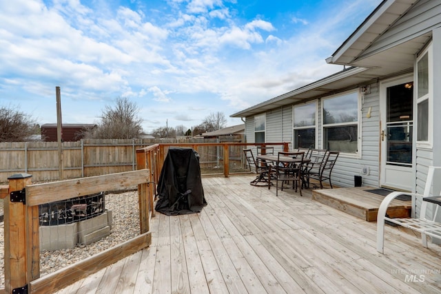 deck featuring outdoor dining space and fence