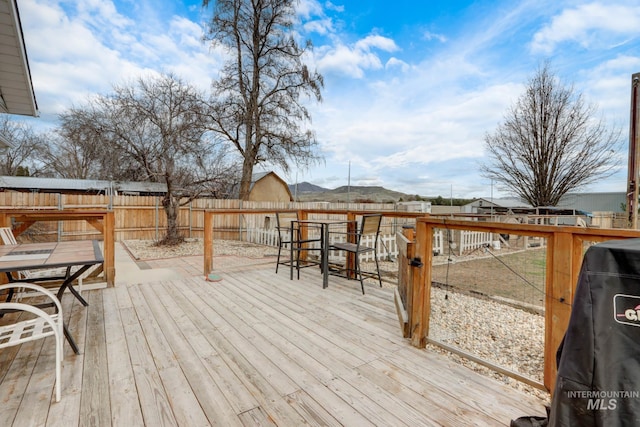 wooden deck featuring a fenced backyard and grilling area