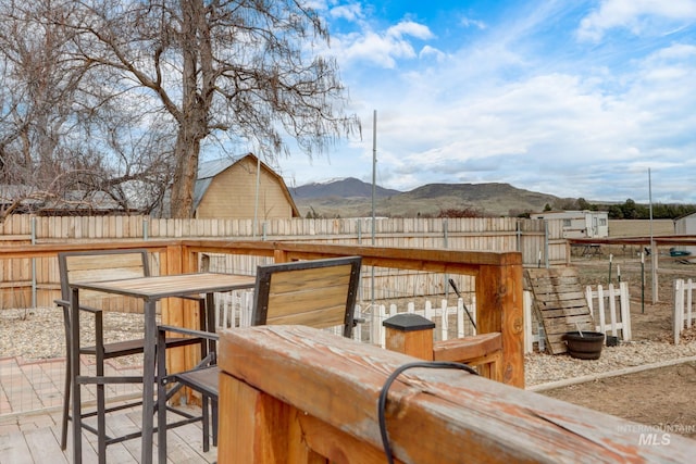 exterior space with a mountain view and fence