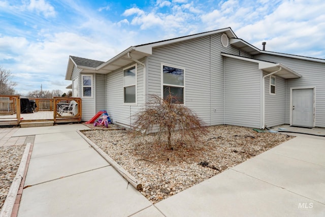 view of property exterior featuring a deck