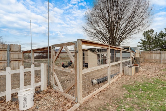 view of yard featuring an outbuilding, fence, and exterior structure