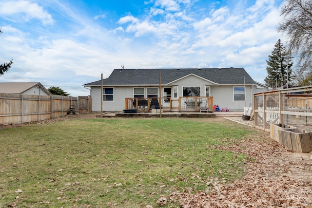 back of house featuring a yard, a fenced backyard, and a wooden deck