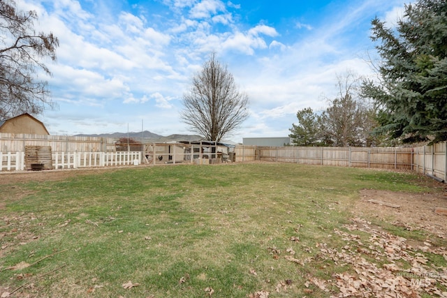 view of yard featuring an outbuilding and a fenced backyard