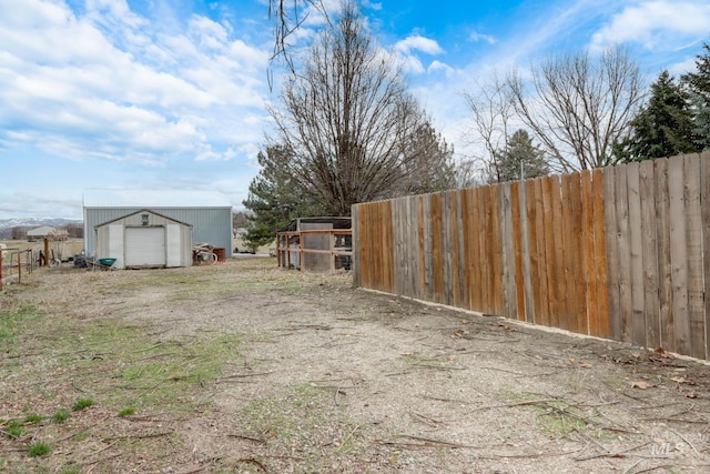 view of yard with an outdoor structure and fence