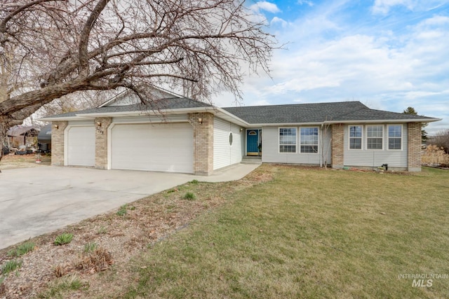 ranch-style home featuring brick siding, a front lawn, concrete driveway, and a garage