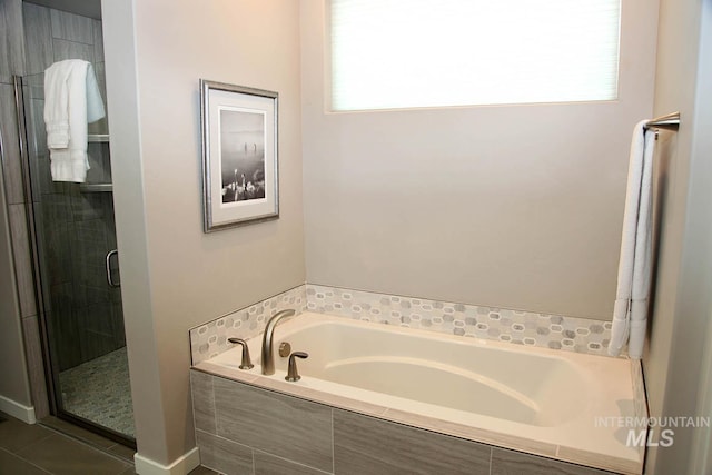 full bathroom with tile patterned floors, a stall shower, and a garden tub