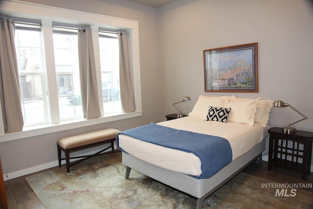 bedroom with wood finished floors and baseboards