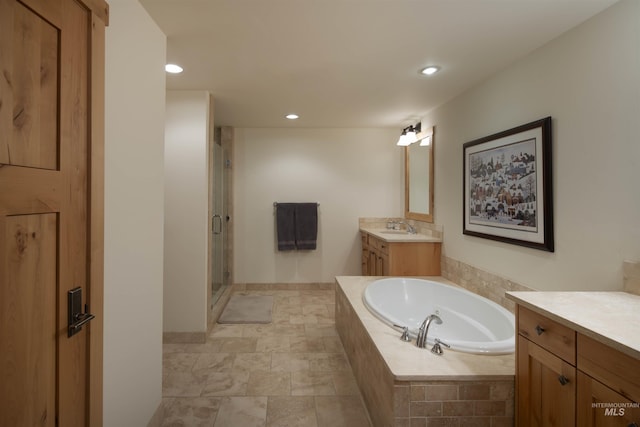 109 Angani Way Unit 15, Sun Valley, ID 83353 - full bathroom featuring vanity, a bath, a shower stall, recessed lighting, and stone finish flooring