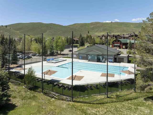 109 Angani Way Unit 15, Sun Valley, ID 83353 - community pool with a hot tub, a mountain view, and a patio area