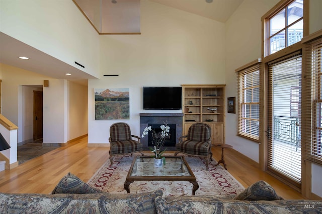 109 Angani Way Unit 15, Sun Valley, ID 83353 - living area with wood finished floors, a tiled fireplace, and a towering ceiling