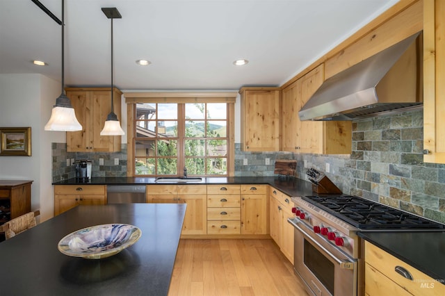 109 Angani Way Unit 15, Sun Valley, ID 83353 - kitchen with appliances with stainless steel finishes, wall chimney exhaust hood, dark countertops, light brown cabinets, and light wood-style floors