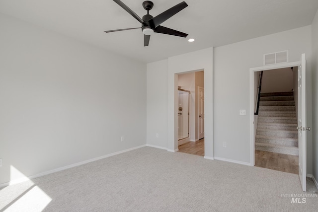 unfurnished bedroom with visible vents, recessed lighting, connected bathroom, carpet flooring, and baseboards