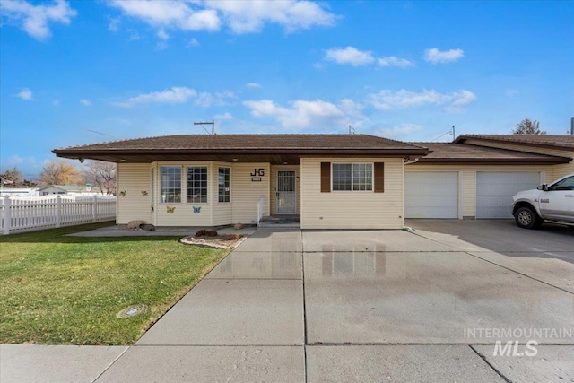 ranch-style house featuring a garage and a front lawn