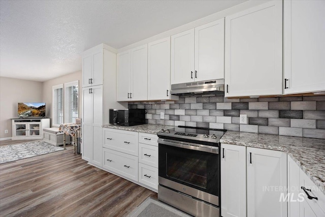 kitchen with a textured ceiling, white cabinets, hardwood / wood-style flooring, stainless steel electric range oven, and light stone counters