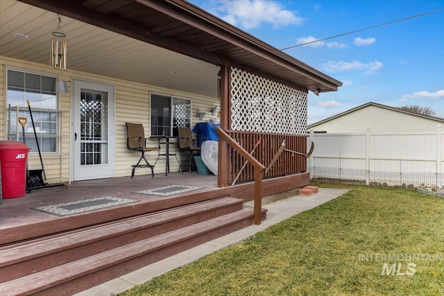 wooden terrace with a yard