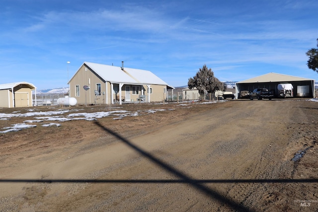 view of front of house with a shed and a carport